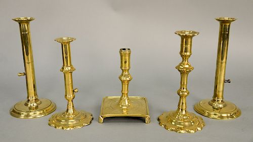 Five brass candlesticks including two Queen Anne push-ups with scalloped bases.  ht. 6 1/2 in. to 9 1/4 in.