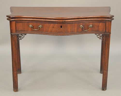 George II game table having serpentine top over conforming drawer, set on fluted legs, 18th century.  ht. 29 in., wd. 40 in.