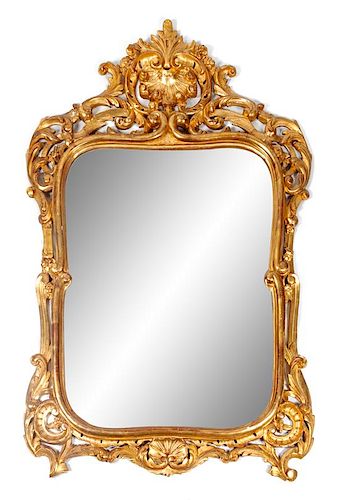 A Louis XV Style Giltwood Mirror Height 58 x width 38 inches.