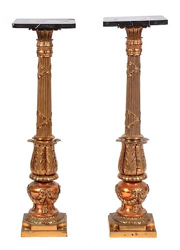 * A Pair of Gilt Metal and Black Marble Top Pedestals Height 39 inches.