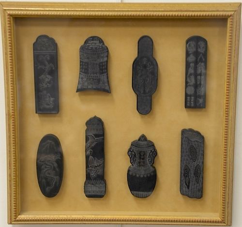 Set of eight black stone seals, having carved dragons, phoenix birds and one in the form of an urn with cover.  12 1/4" x 12 1/2"