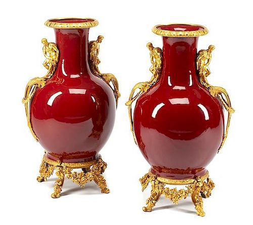 A Pair of French Gilt Bronze Mounted Sang de Boeuf Vases Height 30 inches.