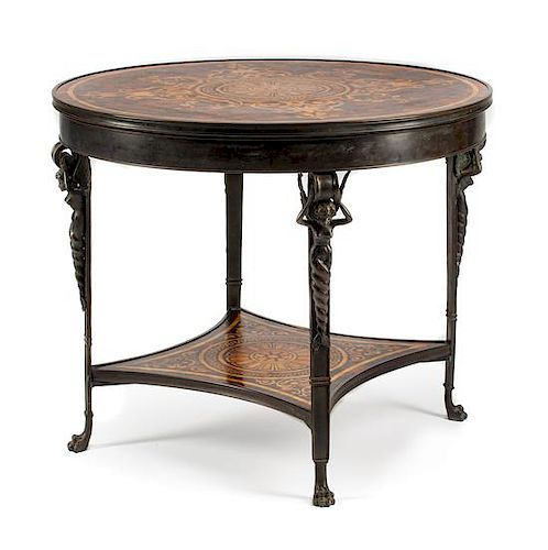 An Empire Style Patinated Bronze Table Height 29 x diameter of top 36 inches.