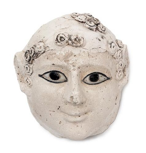 * An Egyptian Stucco Funerary Mask of an Infant Height 8 inches.
