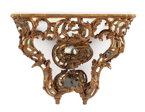 A Venetian Mirror-Inset Giltwood Console Table Height 34 x width 44 x depth 16 1/2 inches.