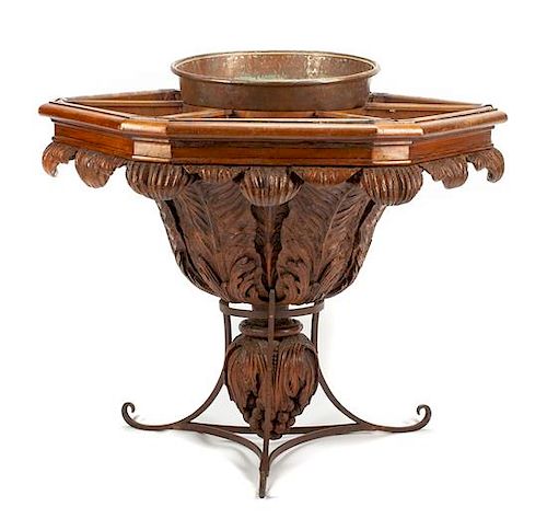 A Continental Carved Walnut and Wrought Iron Hexagonal Jardiniere Table Height 40 x width 43 inches.