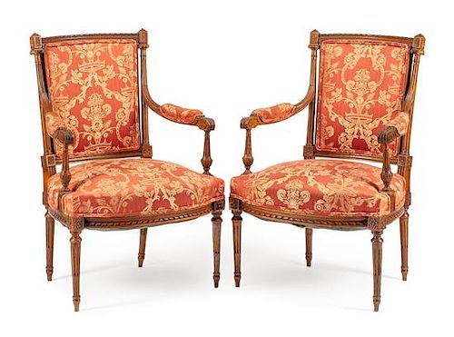 A Pair of Louis XVI Style Walnut Fauteuils Height 38 inches.