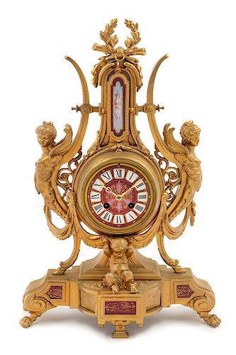* A French Neoclassical Porcelain Mounted Gilt Metal Mantel Clock Height 19 x width 12 1/2 x depth 2 1/2 inches.