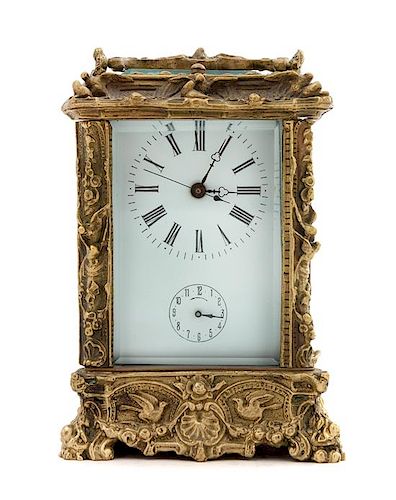 * A French Gilt Bronze Carriage Clock Height 6 3/4 x width 4 3/8 x depth 4 inches.
