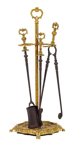 A Set of French Gilt Bronze Fireplace Tools Height of stand 31 inches.