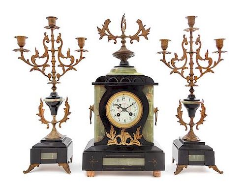 * A Continental Gilt Metal Mounted Onyx and Slate Clock Garniture Height of clock 20 1/2 x width 9 1/2 x depth 5 1/2 inches.