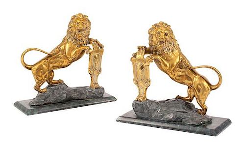 A Pair of English Gilt Bronze Lion Ornaments Width of base 16 inches.