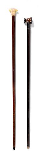 Two Continental Walking Sticks Length of longer 36 1/2 inches.
