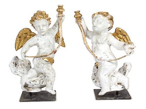 A Pair of Italian Carved Painted, and Parcel Gilt Putti Single Light Candelabra Height 22 3/4 x width 13 x depth 13 inches.