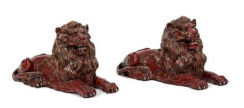 A Pair of Italian Glazed Recumbent Lions Length 30 inches.