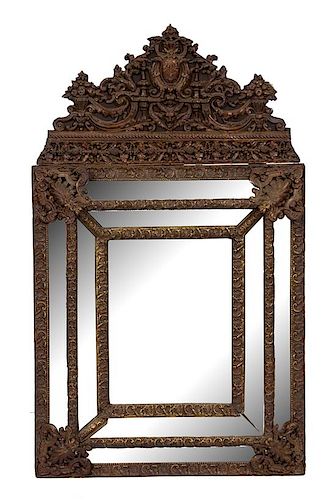 A Dutch Repousse Brass Cushion Mirror Height 51 x width 30 inches.