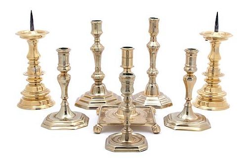 A Group of Eight Continental Brass Candlesticks