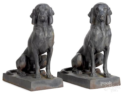 Pair of cast iron garden figures of seated hounds
