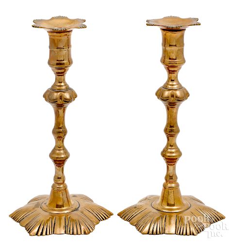 Pair of George II brass shell base candlesticks