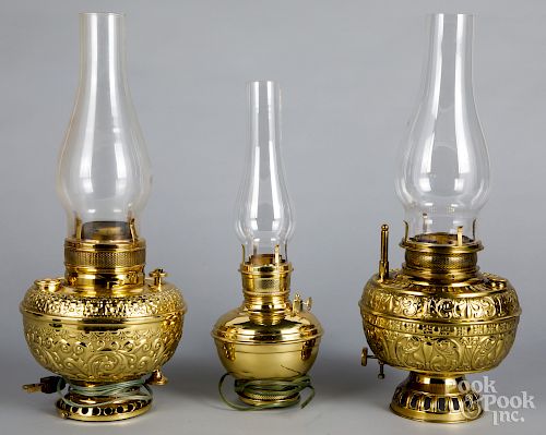 Three brass kerosene lamps