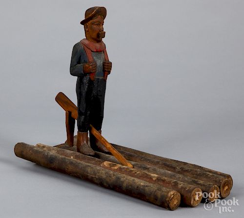 Carved and painted figure of a man on a raft