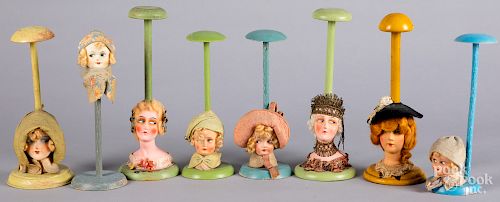 Eight painted composition flapper doll hat stands