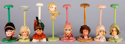 Eight painted composition flapper doll hat stands