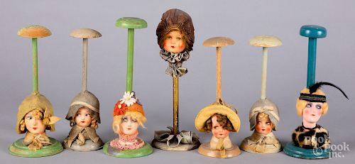 Seven painted composition flapper doll hat stands