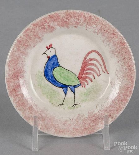 Red spatterware rooster cup plate, 19th c., 3 1/4'' dia. Provenance: An Alexandria, Virginia estate