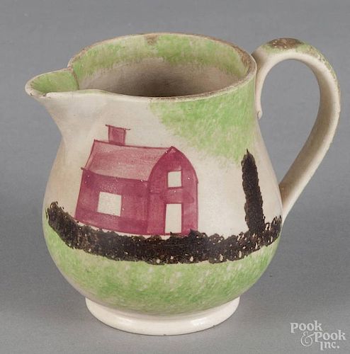 Green spatterware schoolhouse cream pitcher, 19th c., 3 3/4'' h.