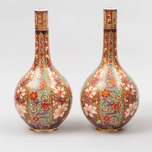 Pair of English Polychrome Decorated Porcelain Bottle Form Vases and Stoppers