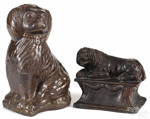 Sewer tile figure of a seated spaniel, 19th c., 10 1/2'' h., together with a redware recumbent lion