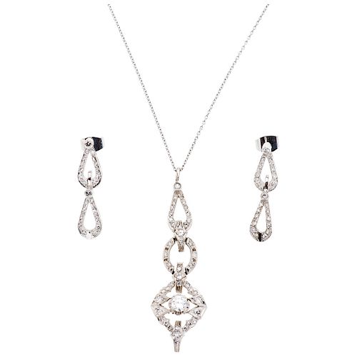 A diamond palladium silver pendant and pair of earrings, and 14K white gold necklace set.