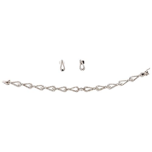 A diamond palladium silver bracelet and pair of earrings set.