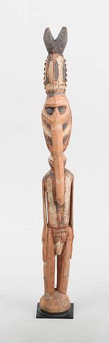 OCEANIC PAINTED WOOD FIGURE OF A MAN WITH A BIFURCATED HEADDRESS