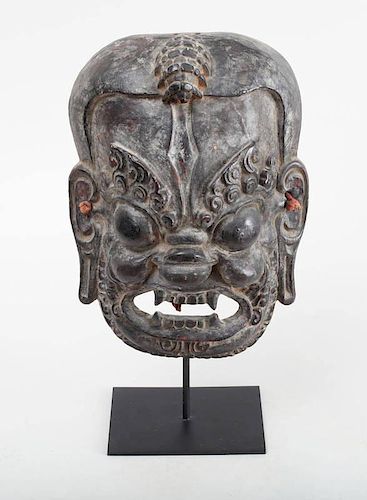BALINESE CARVED AND BLACK-GROUND PAINTED GROTESQUE MASK