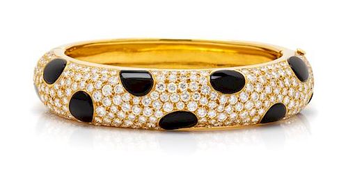 An 18 Karat Yellow Gold, Diamond and Onyx Bangle Bracelet, 43.60 dwts.