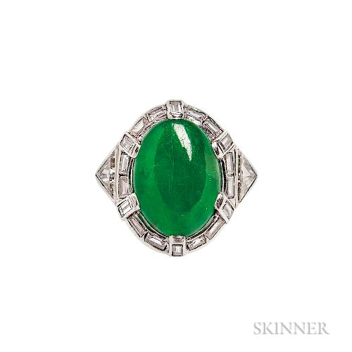 Platinum, Jade, and Diamond Ring, set with an oval cabochon jade measuring approx. 14.20 x 10.70 x 5.30 mm, framed by baguette-cut diam