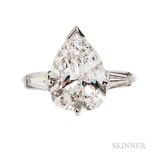 Platinum and Diamond Solitaire, prong-set with a pear-shape diamond weighing 4.24 cts., flanked by tapered baguettes, size 4 3/4. Note: