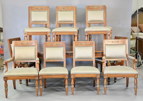 Henredon dining table and twelve chairs with upholstered seats and backs, having banded inlaid top, two extra leaves, and two silver...