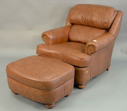 Leather upholstered chair and ottoman. ht. 34 in., wd. 34 in.