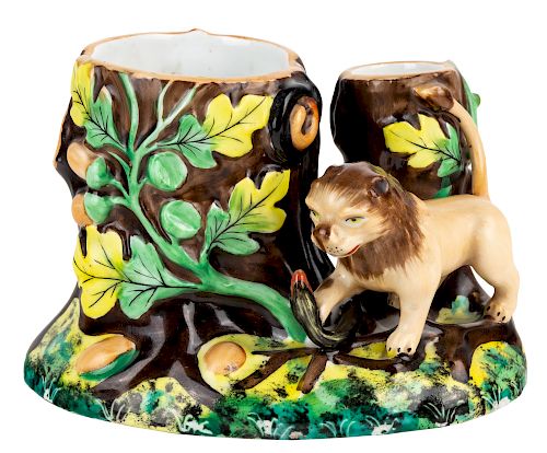 A RUSSIAN PORCELAIN MATCH HOLDER FORMED AS A LION ATTAKING A SNAKE, KUZNETSOV PORCELAIN FACTORY, RIGA, LATE 19TH CENTURY