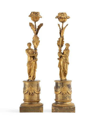 A pair of Empire gilt bronze figural candlesticks