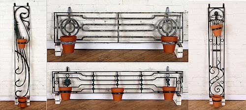A SET OF FOUR WROUGHT IRON WALL MOUNT PLANT HOLDERS