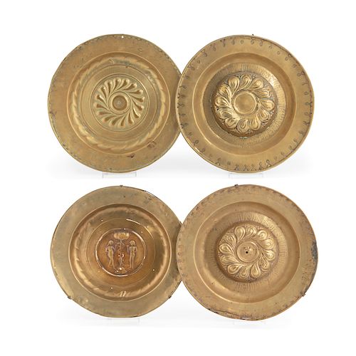 Four Continental brass alms dishes, 17th century