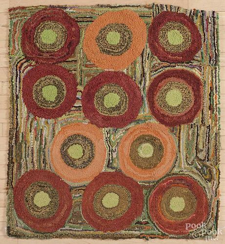 New England hooked rug, ca. 1900, with circles on a scattered ground, 39'' x 43''.
