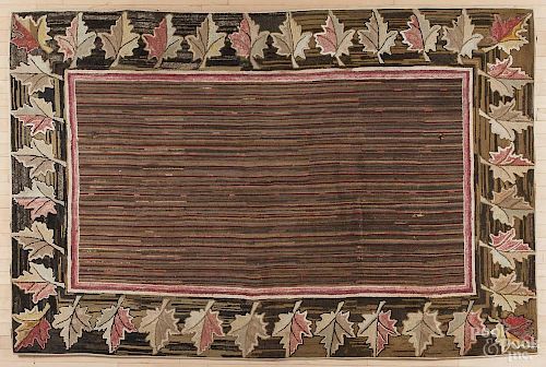 American hooked rug with a leaf border, 104 1/2'' x 68''.