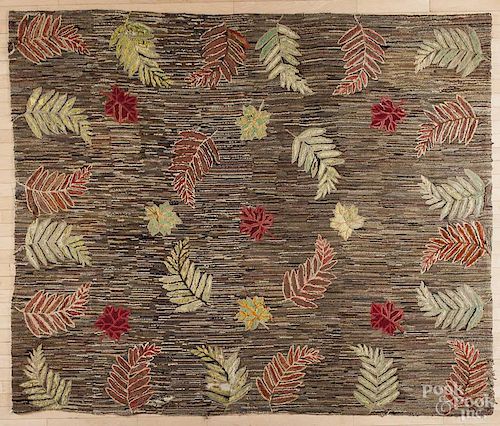 Large American hooked rug with leaves and ferns on a scattered ground, 77'' x 92''.