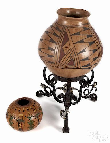 Two contemporary Native American pots, the larger with a wrought iron stand, 8 3/4'' h.