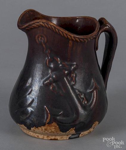 Rockingham glaze pitcher, late 19th c., with relief anchor decoration, 8'' h.